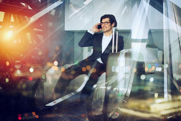 Traveler businessman with his smartphone ready to fly Double exposure