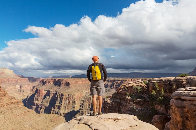 Traveler on cliff mountains over Grand Canyon National Park, Arizona, USA.Inspiring emotion.