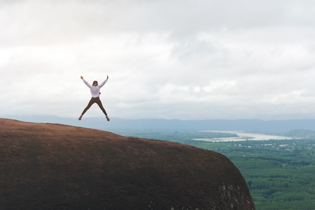 Traveler feeling freedom jump on nature background