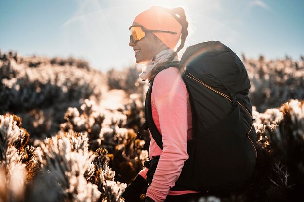 Traveler hiking with backpacks Hiking in mountains Sunny landscape Tourist traveler on background view mockup High tatras slovakia