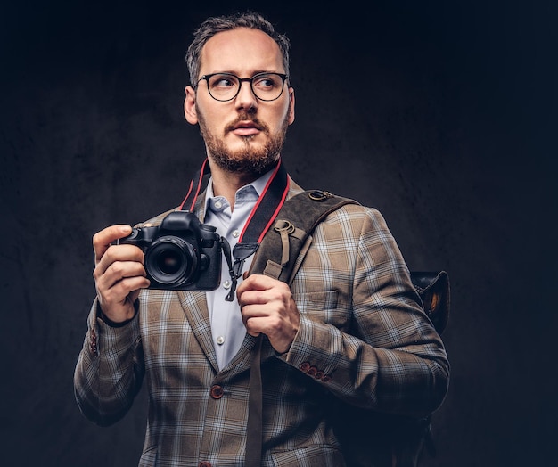 Traveler and photographer. Studio portrait of a handsome bearded