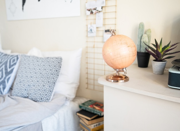 Traveler's room. The globe is standing by the bed. Rustic