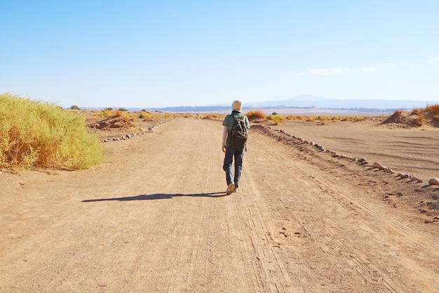 Traveler Walking on the Desert Road of Aldea de Tulor Archaeological Site in Atacama Desert Chile