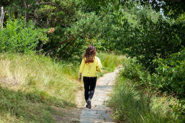 Traveler woman in forest road