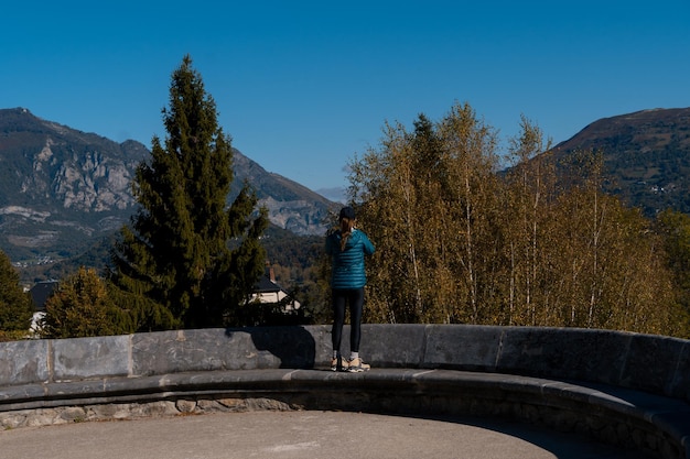 Traveler woman taking picture with her mobile phone of the mountains in Saint Savin France