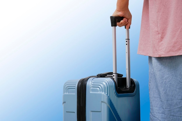 Traveler woman walking carrying a suitcase.