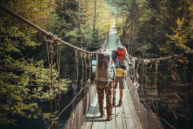 Travelers crossing through hanging bridge