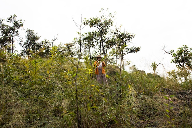 Travelers thai women people travel visit rest relax and hiking trekking trail and take photo on viewpoint rock mountain forest of Khao Lon Adventure Point at Sarika in Nakhon Nayok Province Thailand