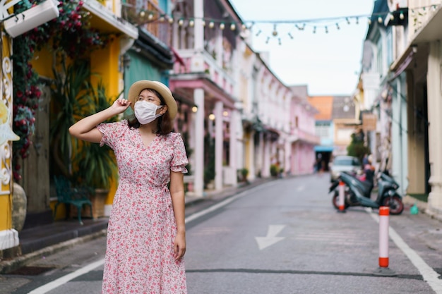 Travelers with mask walking on street Phuket old town with Building Sino Portuguese architecture at Phuket Old Town area Phuket Thailand Travel concept and summer trip