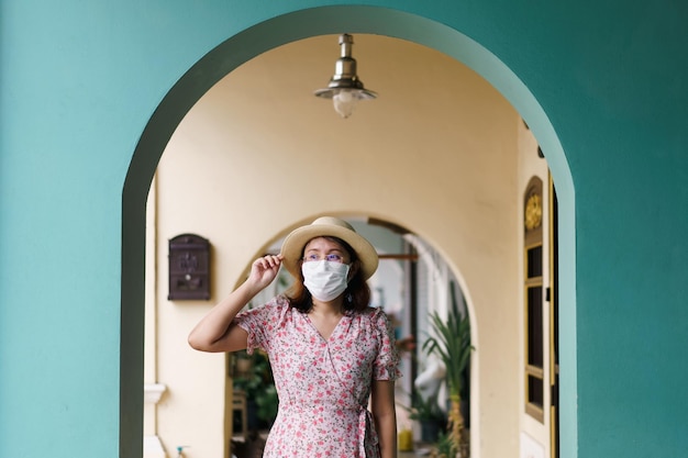 Travelers with mask walking on street Phuket old town with Building Sino Portuguese architecture at Phuket Old Town area Phuket Thailand Travel concept and summer trip