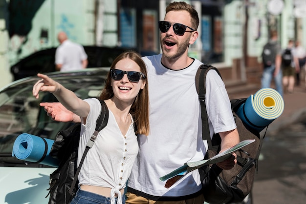 Traveling couple looking for directions