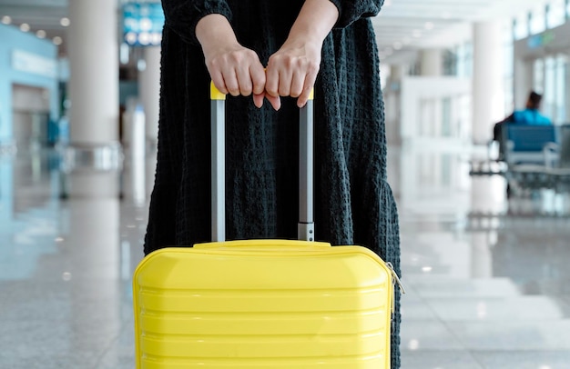 Traveling girl with a suitcase at the airport vacation planes flights travel concept high quality ph