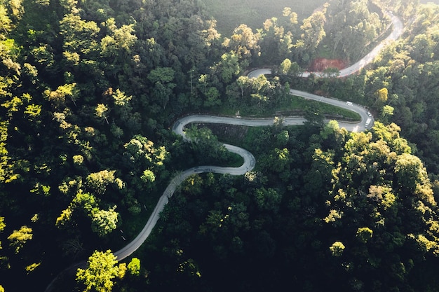 Traveling on winding mountain roadAerial View Of Winding Road Amidst Trees