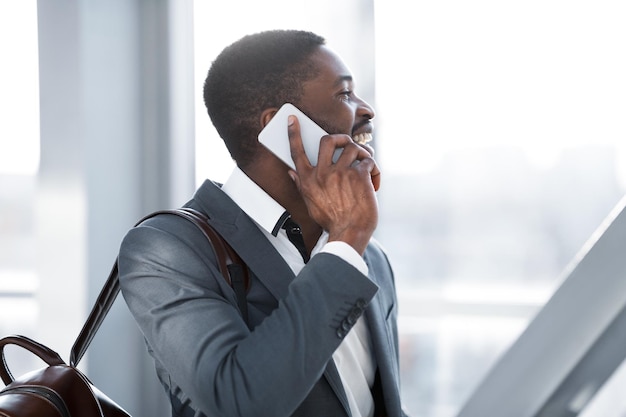 Travelling Businessman Making Phone Call Arriving at Airport