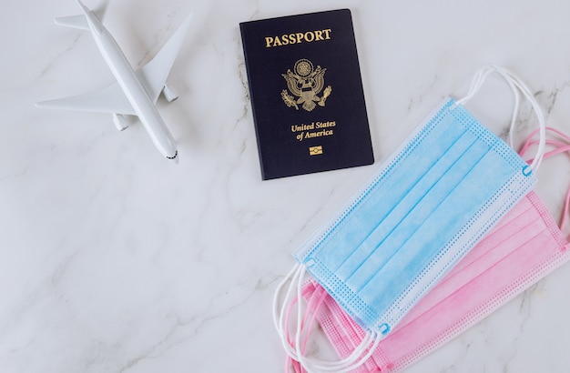 Travelling during the coronavirus outbreak with vaccine infection prevention immunization in the travel face mask, USA passport