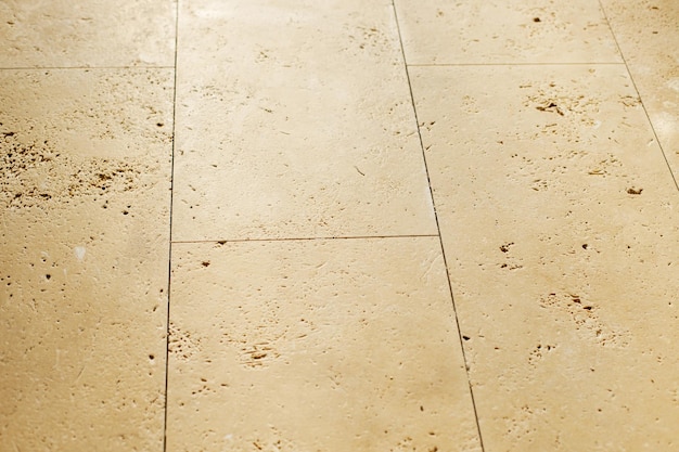 Travertine tiles masonry on floor in bathroom Construction of house and home renovation concept Stylish natural travertine stone tile close up