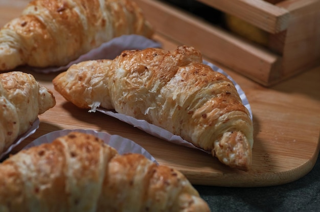 A tray of croissants with a white paper liner on top