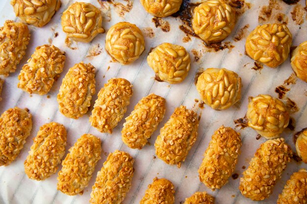 A tray of peanut butter cookies with peanut butter on top.