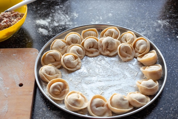 Tray of raw dumplings for cooking Cooking homemade dumplings