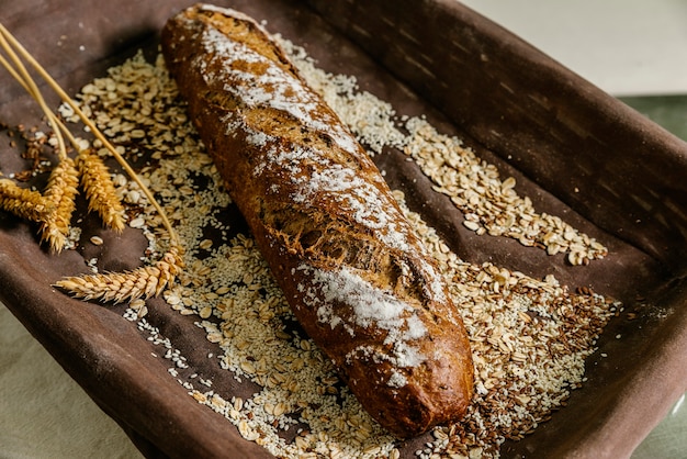 Tray with bread, seeds and ears of wheat