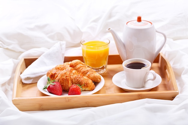 Tray with cup of coffee and croissants