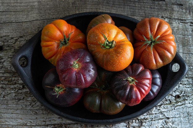 Tray with raf tomatoes and blue sea on old wood background Copy space