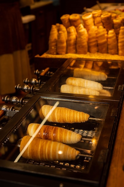 Trdelnik or trdlo is traditional Czech sweet Prague street food National Czech food sweet dessert trdlo Useful tasty roll trdlo on the street market