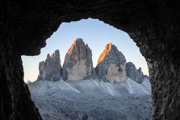 Tre Cime Di Lavaredo peaks in incredible orange sunset light View from the cave in mountain against Three peaks of Lavaredo Dolomite Alps Italy Europe Landscape photography