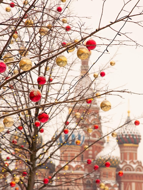 Tree decorated with lights and balls against background of the Russian cathedral, Moscow, Russia