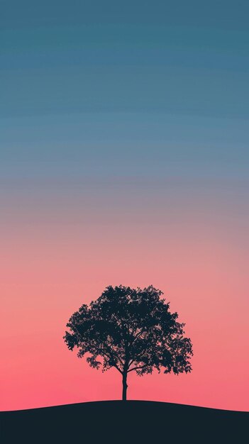 Photo tree silhouette stands against gradient sunset sky