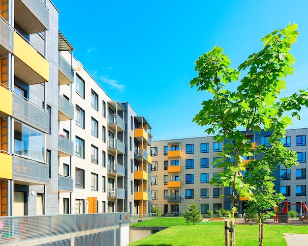 Trees at complex of new apartment residential buildings with outdoor facilities.