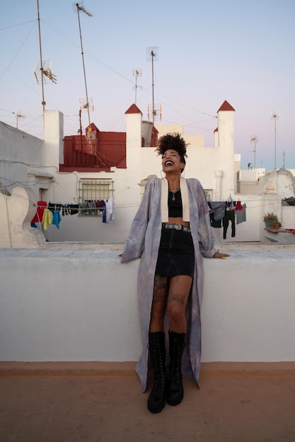 Trendy black female resting on terrace in Cadiz Spain