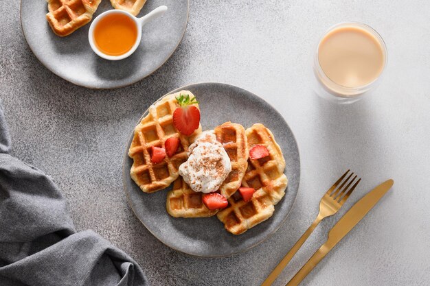 Trendy breakfast with croffles and morning coffee strawberries Croissant as waffle