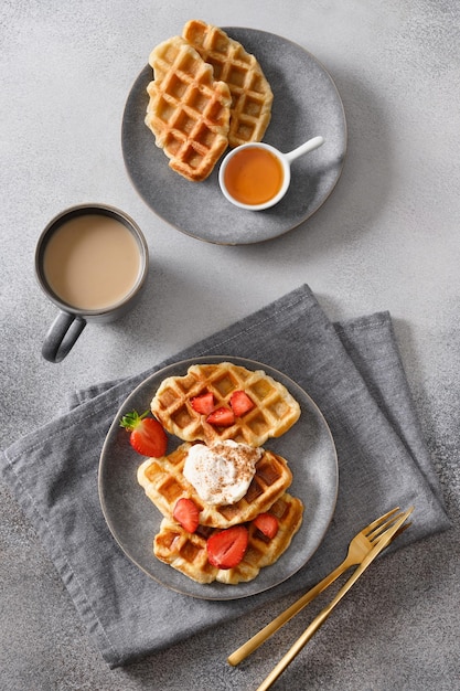 Trendy breakfast with croffles and morning coffee strawberries Croissant as waffle