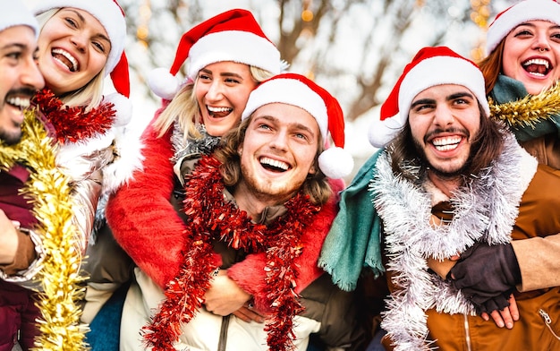 Trendy friends walking around winter travel location on piggy back move