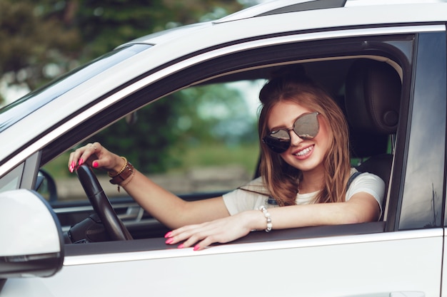 Trendy girl traveling by car