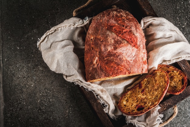 Trendy healthy food, superfood. Homemade beet bread with organic beetroot, in wooden try