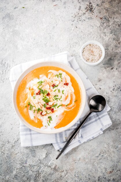 Trendy vegan food, Sweet Potato Detox Soup with coconut milk, dried tomatoes, peanuts and herbs