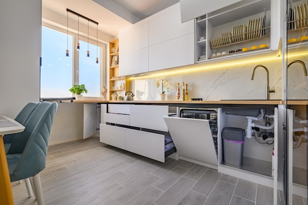 A trendy white kitchen with drawers pulled out to their full length