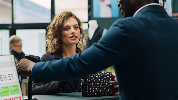 Trendy woman prepared to buy designer bag at store checkout