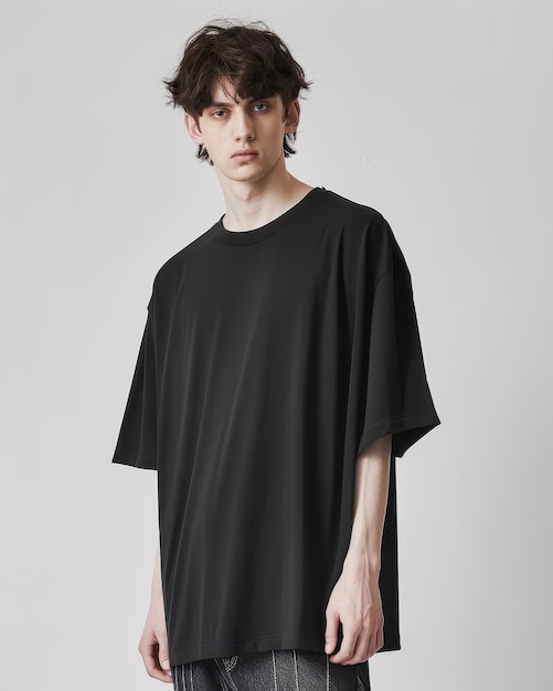 Photo trendy young man wearing a stylish black oversized tshirt showcasing modern fashion and casual sty