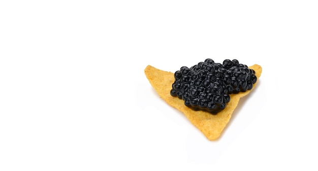 Triangular nachos with black paddlefish caviar isolated on white background Snack copy space