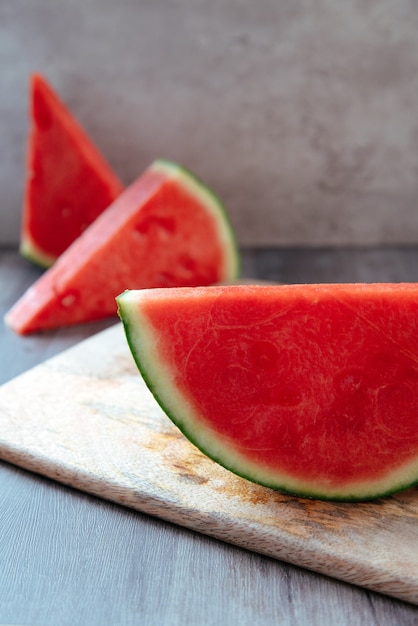 triangular pieces of watermelon on a motherboard with half an organic watermelon at the bottom