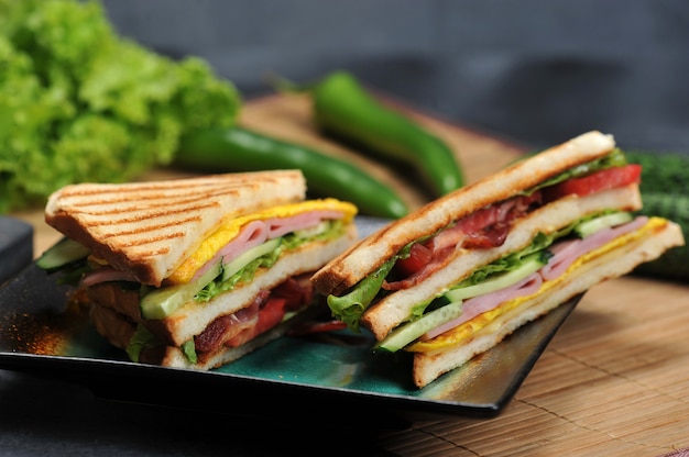 Triangular shaped sandwiches with ham and omelet on a plate