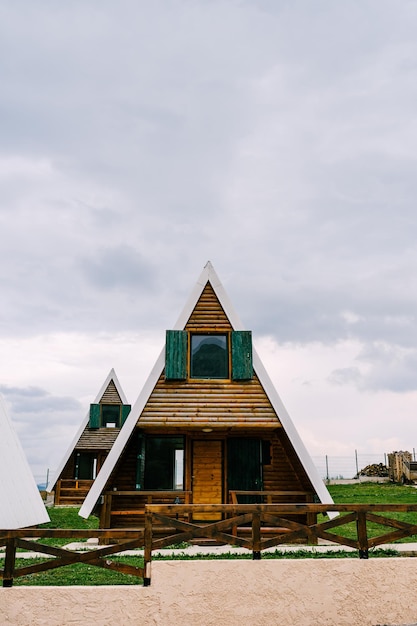 Triangular twostorey houses behind a wooden fence in the north of montenegro