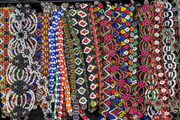 Tribal colorful beads bracelets for sale for tourists at the street market in Kota Kinabalu, island Borneo, Malaysia, close up