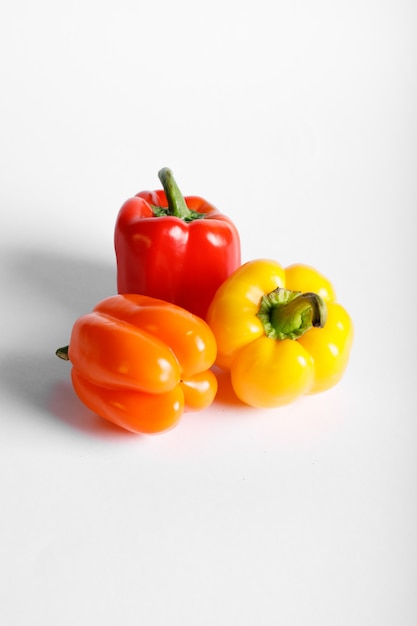 Tricolor peppers isolated on white