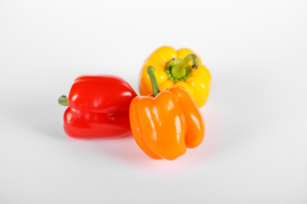 Tricolor peppers on white. Top view