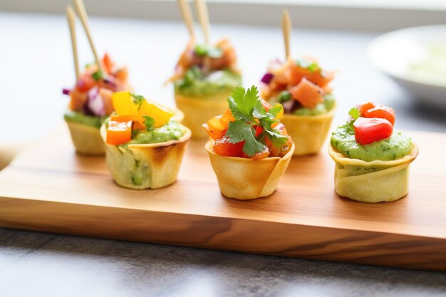 Photo trio of mini nacho bites with a guacamole topping