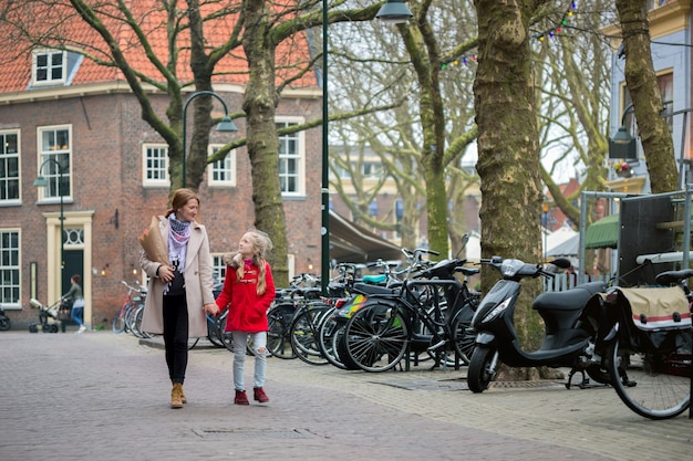 Trip across Europe. happy mother and daughter stroll around the old city delft, netherlands